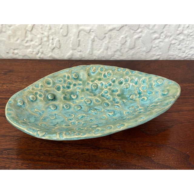Studio made pottery dish with an abstract shape and design. Has a coastal and contemporary feel. Maker's mark on base....