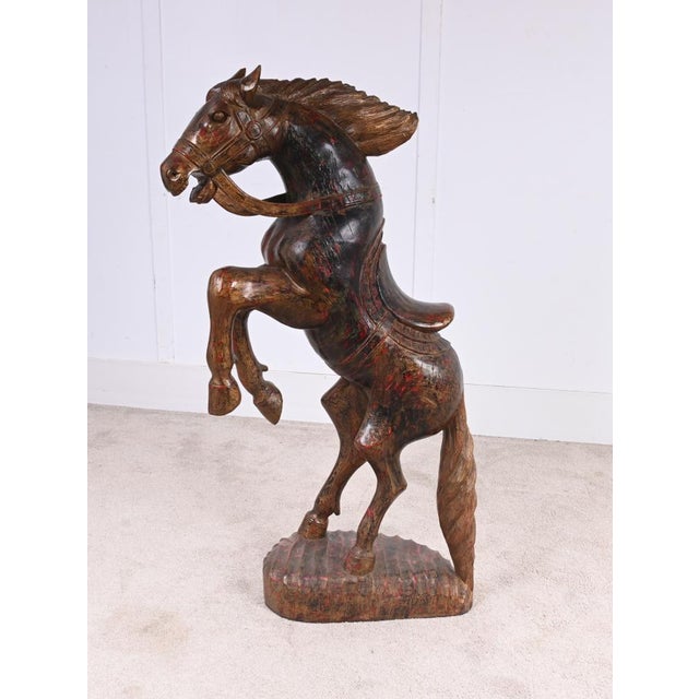 A decorative Italian Florentine carved wooden sculpture of a rearing horse, dating to around 1920. The figure is boldly...