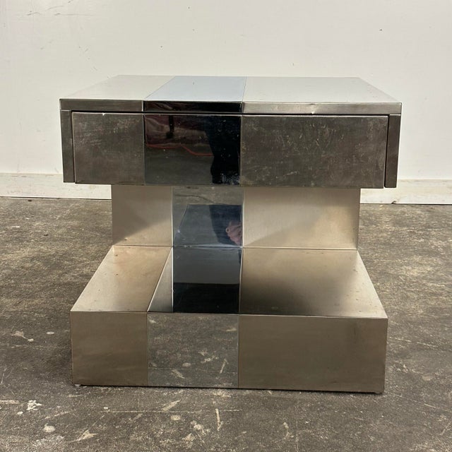 This is a post modern side table in the style of Paul Evans featuring a brushed metal and chrome body. This side table has...