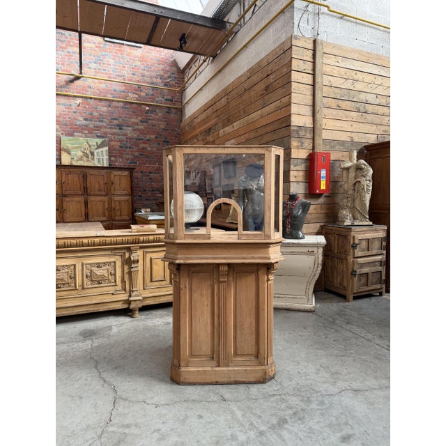 Vintage pine reception desk. It features an upper section with glass panels (glass sides and a acrylic glass front). At...