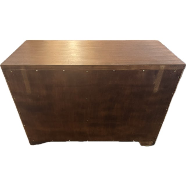 An American low three-drawer chest (bachelor’s chest / bedroom-suite piece), c. late 1940s–mid 1950s, in ribbon-stripe...