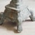 Historicist decorative column in a weathered stone look with an Ionic capital and volute feet. The square top plate serves...