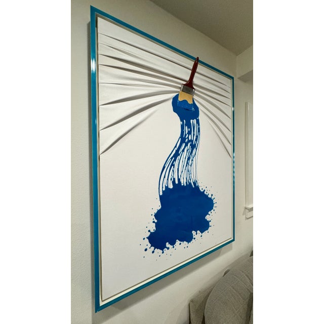 Brushes and Rollers by artist Elis Mashiah. Painted canvas with paint brush projecting from canvas. Lacquered blue frame....