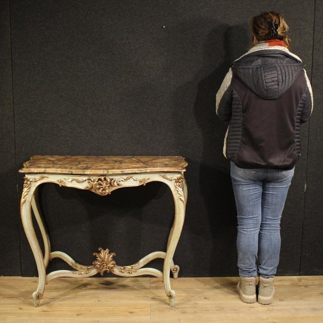 French console table from the mid-20th century. Finely carved, lacquered, and silvered wood furniture in the Louis XV...