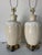This striking pair of 1980s vintage table lamps features sculptural ceramic bodies in a soft beige glaze, accented by an...