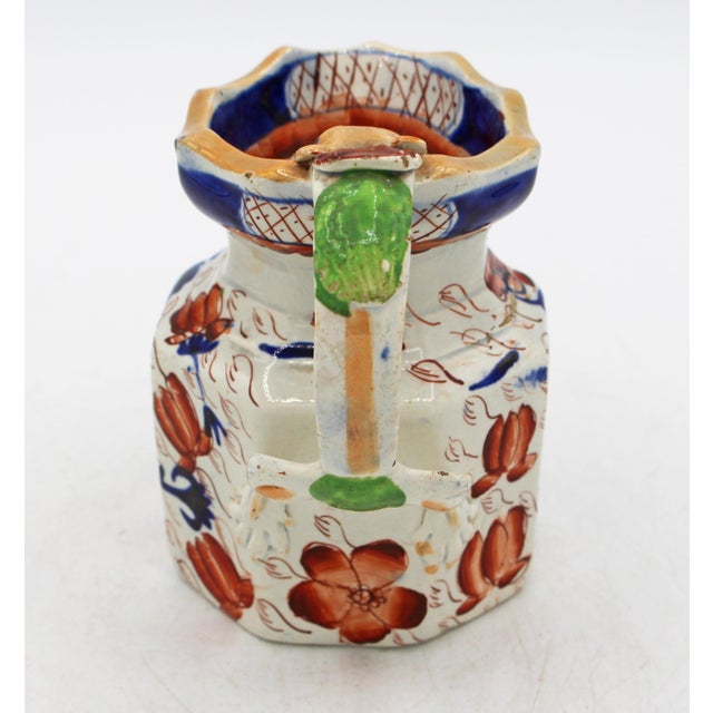 Mid-19th century small Ironstone octagonal jug with dragon handle, English. Impressed mark "Ironstone China". In the...