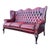 English high-back Chesterfield sofa in burgundy leather with deep button tufting, rolled arms, and nailhead trim. Raised...