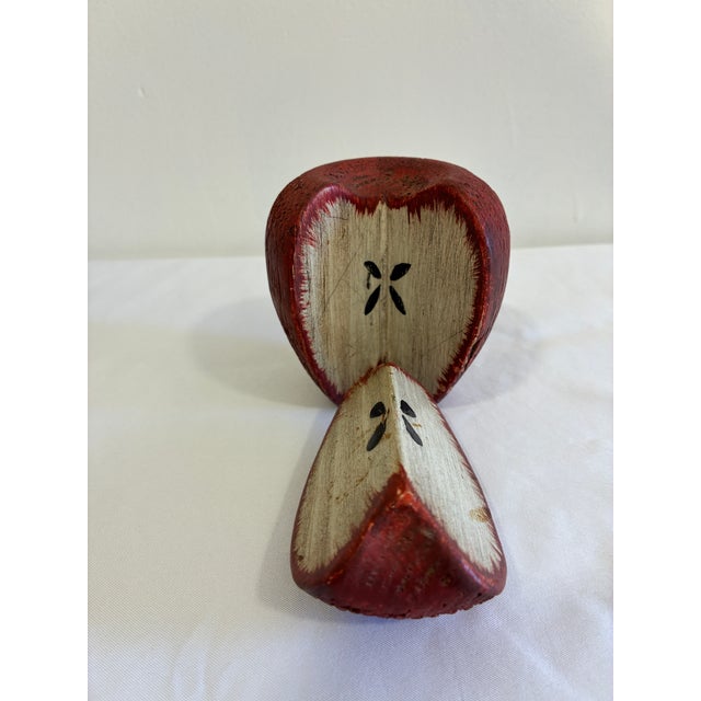 This carved wood apple sculpture is signed "C. Colby" and made in Maine, USA, painted a rich red with a natural wood...