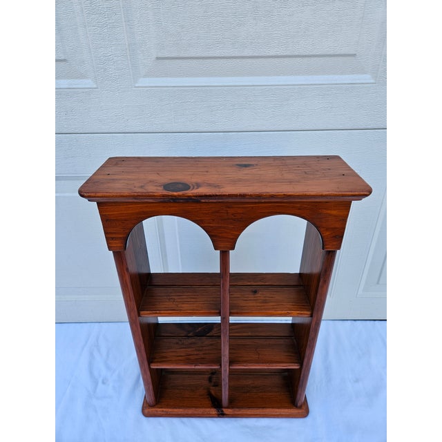 A classic pine wall mount shelf unit with three shelves, each with a plate edge. This piece is by Ethan Allen so you know...