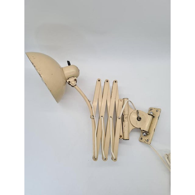 An original German scissor-type wall lamp manufactured by the renowned company Kaiser Leuchten. A classic model with a...