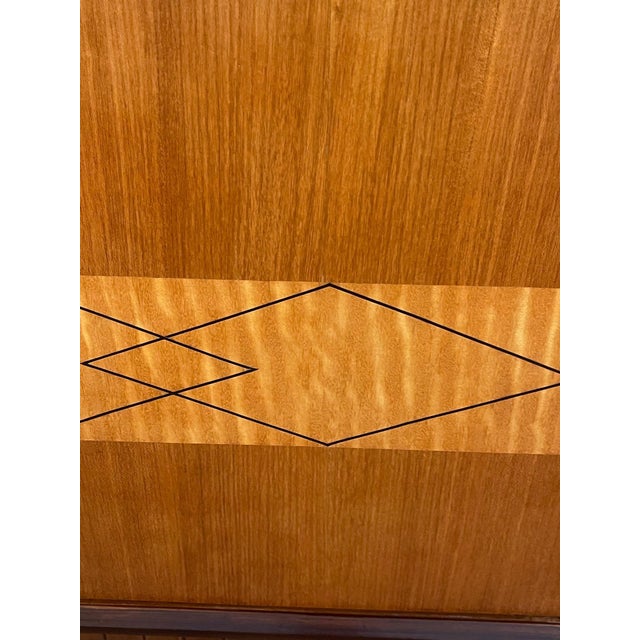 A refined and visually striking Italian mid-century modern six-door sideboard, circa 1960's, showcasing elegant...