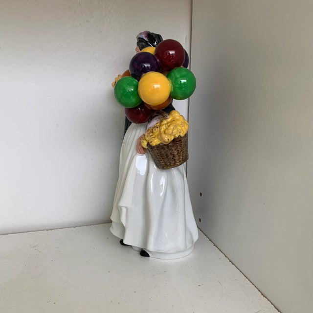 Made by Royal Doulton. H.N. 1843 "Biddy" Penny Farthing Balloon Figure. Designer: L. Harradine. 9" in height. Various...