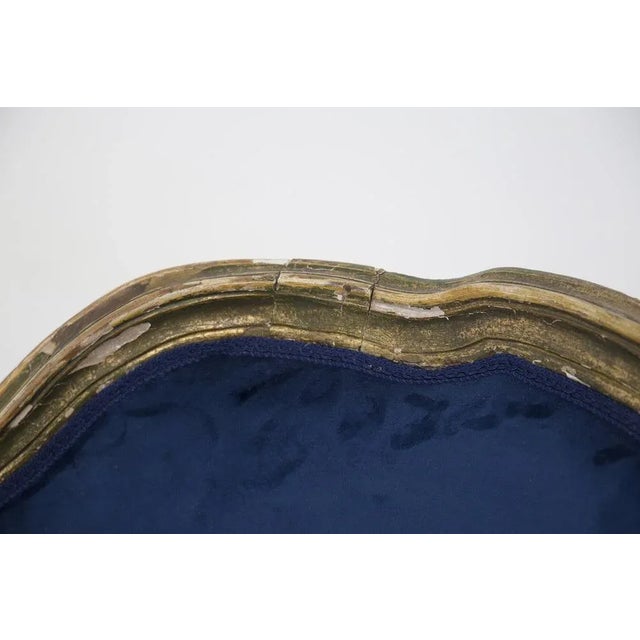 Eccentric antique giltwood and velvet armchair from the late 1800s and early 1900s, fine Italian manufacture. The armchair...