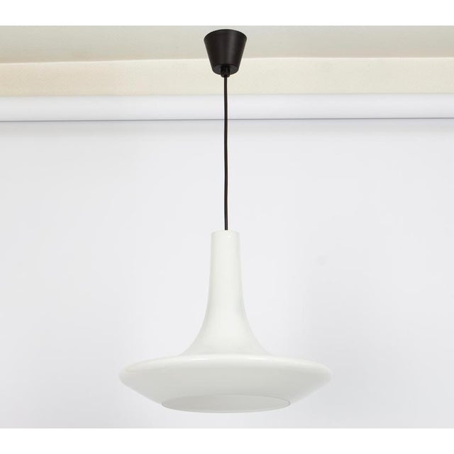 A special form of opal glass pendant designed by koch & lowy for peill & putzler, manufactured in germany, circa 1970s....