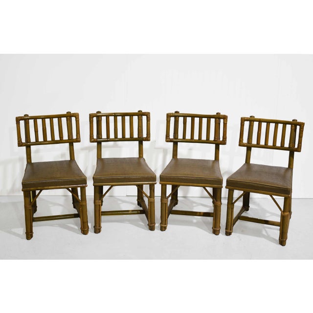 An iconic design moment. This set of four Mid Century rattan dining chairs was designed by John Wisner for Ficks Reed, a...