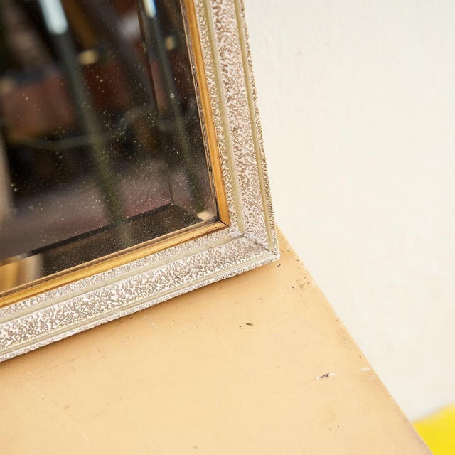 This stunning vintage mirror features a gold frame decorated with an elegant texture that adds a touch of sophistication...