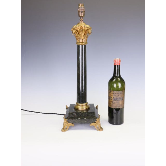 Antique 19th century french black marble column table lamp with gilt rococo an exceptional french 19th-century table lamp...