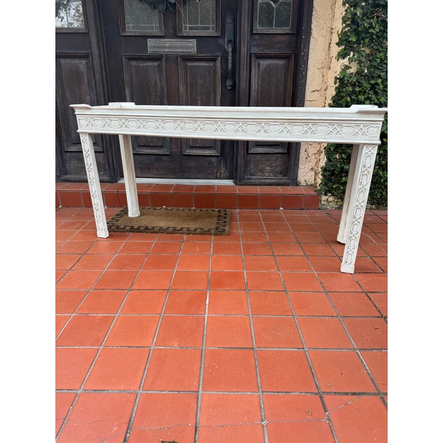 Distressed white Baker sofa table. High quality and sturdy. Beautiful carved fretwork on legs and apron. A classic and...