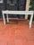 Distressed white Baker sofa table. High quality and sturdy. Beautiful carved fretwork on legs and apron. A classic and...