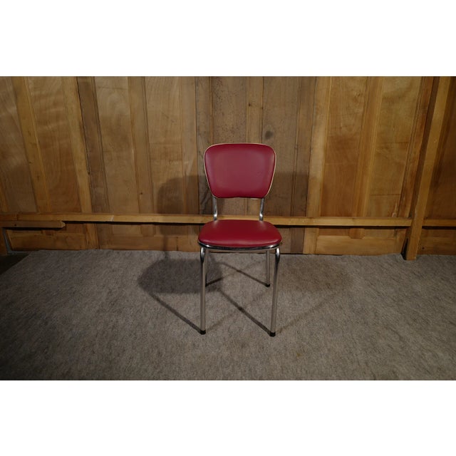 Dissimilar bistro style chairs. In black imitation leather (back and orange cotton piping) the second in burgundy...