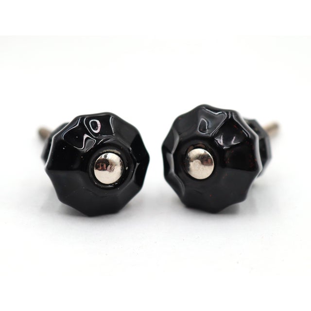 Vintage cabinet or drawer knobs made of black glass with a fluted shape. The original mounting nuts are not included. Good...