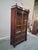 Impressive French Napoleon III library bookcase crafted in richly figured mahogany with original glass doors, brass-...