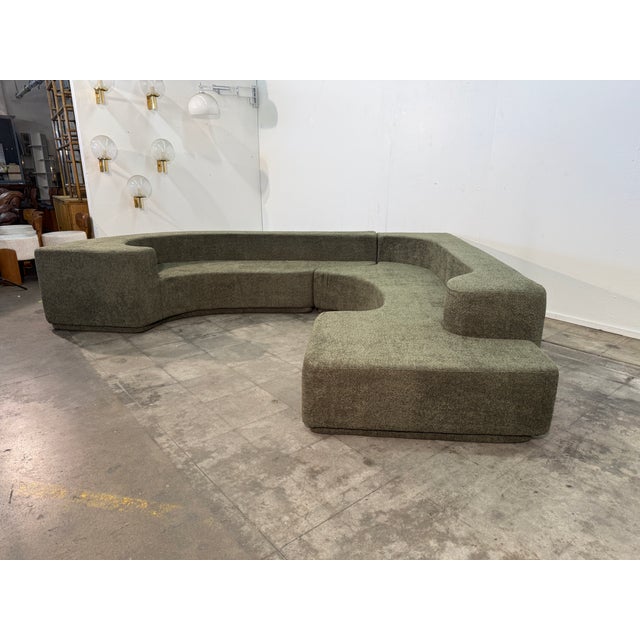 A sculptural modular sofa defined by its fluid, architectural silhouette and generous proportions. Composed of multiple...