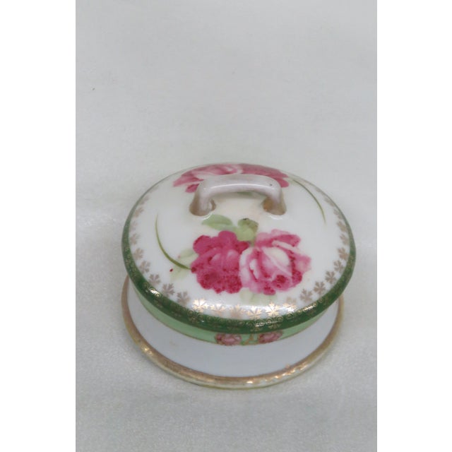 This lovely lidded Powder Dish is made out of porcelain. This Powder Dish is made in Japan by I E & C Co and it is...