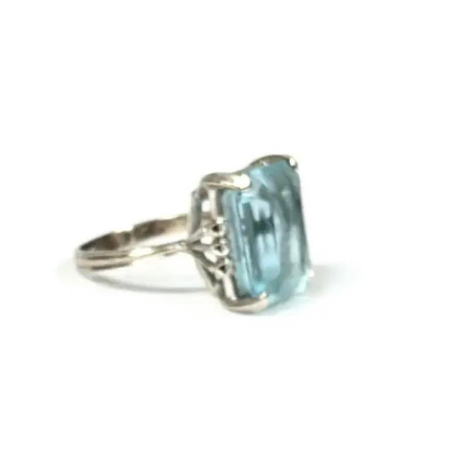 Vintage H. Stern 18K Gold Aquamarine and Diamond Cocktail Ring. Aquamarine stone is in an emerald cut flanked by six...
