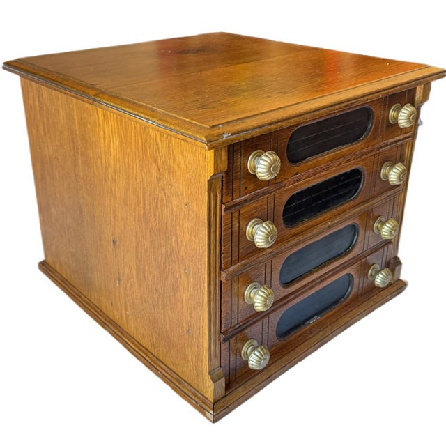 A wonderful example of early American mercantile advertising, this authentic Goff's "Best Braid Made" oak spool cabinet...