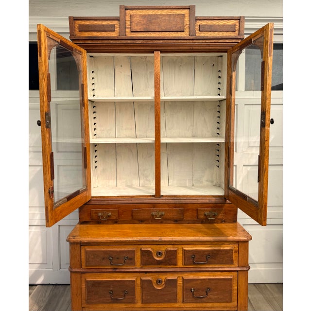 Here is a stunning antique, late 1800-early 1900s oak display cabinet on chest with wonderful architectural detailing and...