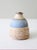 This is a vintage studio pottery jar. Signed by the artist, the handmade wheel turned vessel features a speckled tan glaze...