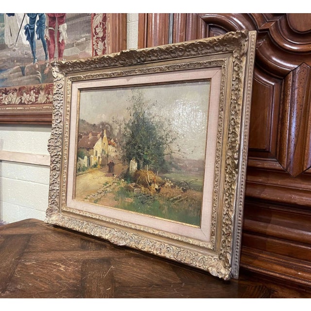 A quiet country road winds through a picturesque French village in this antique landscape painting by Eugène Galien-Laloue...