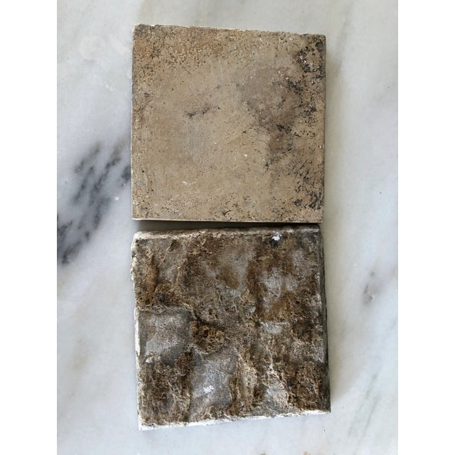 A pair of individual delft earthenware tiles, all with a blue and white country scene, made in the Netherlands during the...