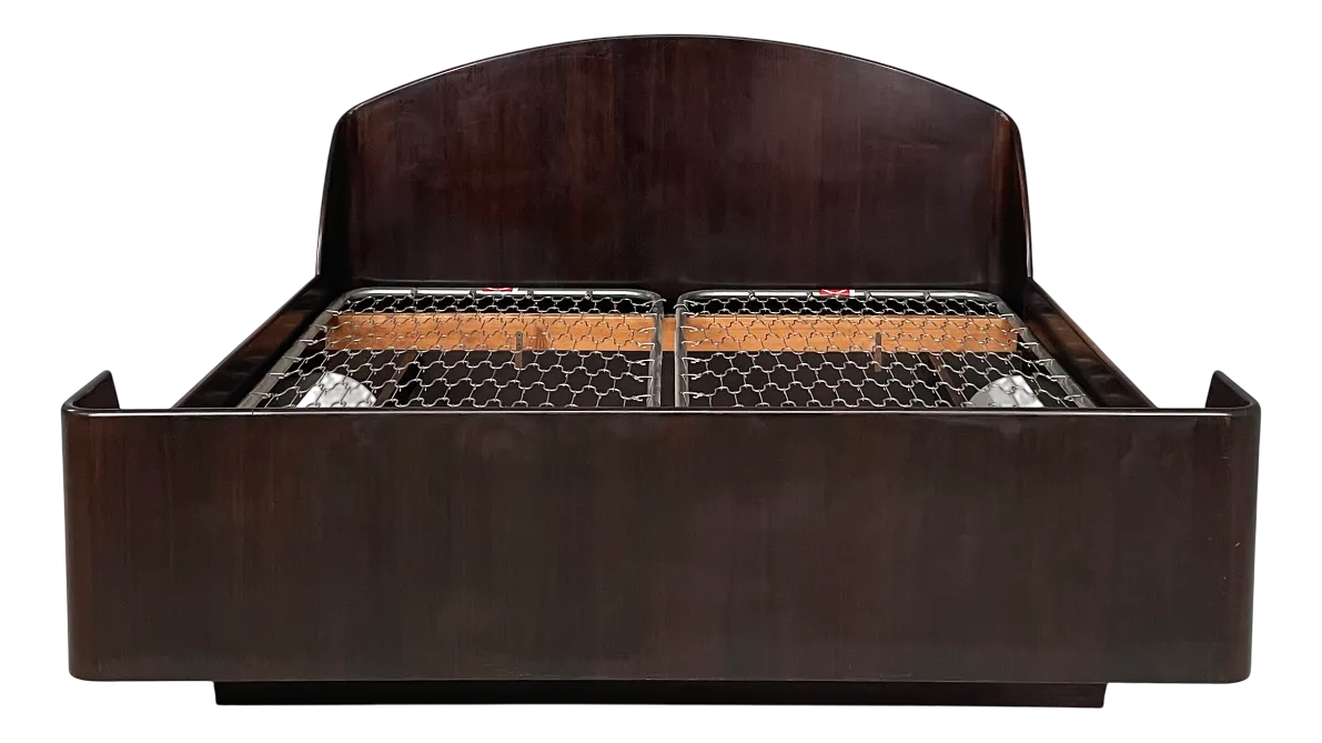 Front view of a wooden double bed frame with a wire mesh mattress.
