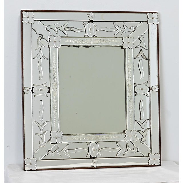 Italian Venetian style wall mirror, early to mid 1900s, its multitude of glass elements composed in a thick wooden frame....