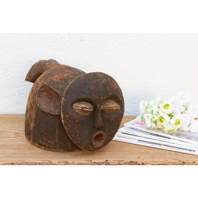 A captivating piece of African heritage, this Mambila mask from Cameroon showcases a distinctive elongated shape and...