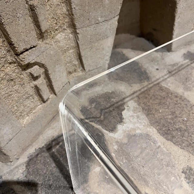 For your consideration, a vintage modern waterfall lucite coffee table. Classic Lines. Unmarked. Dimensions: 14" H x...
