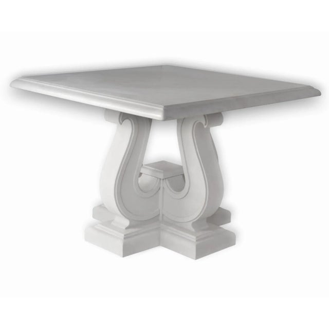 Elegant coffee table with square white marble-top and four-volutes base in white lacquered wood. Total white effect...