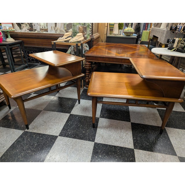 Pair of original Mid-Century Lane Two Tier Side Table. Mixed hardwoods with an interesting dove-tail inlay accent on the...