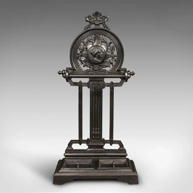 This is an antique ornate stick stand. An English, cast iron hallway umbrella rack, dating to the late Victorian period,...