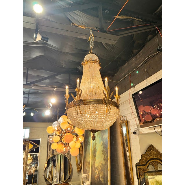 The French Louis XVI Style Gilt Bronze and Crystal Basket Chandeliers adds a touch of elegance to any living room. These...