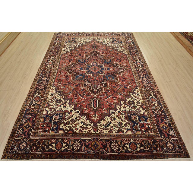 An authentic vintage traditional tribal Heriz rug hand-knotted with fine wool and natural dyes. This rug features a...