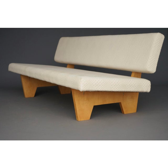 A compact sofa most likely of Dutch origin and designed in the 1950s by a unknown maker. The sofa has a later upholstery...