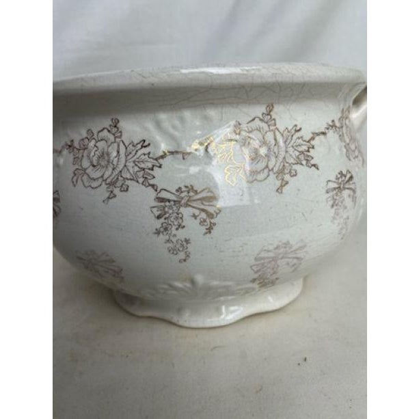 Embossed White With Gold Flowers and Bows. Artist- Homer Laughlin.