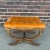 Traditional ornate ottoman with tufted orange cushion and painted gold base