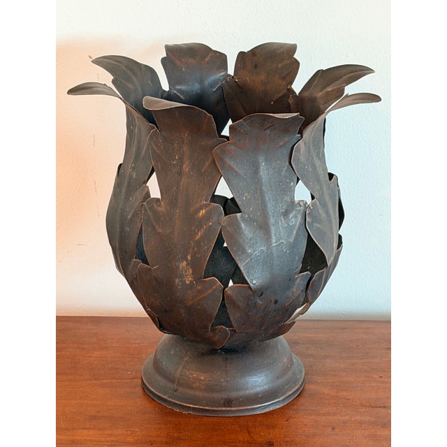 Vintage Hollywood Regency style metal leaf cachepot or planter/pillar candle holder. It is constructed from patinated,...
