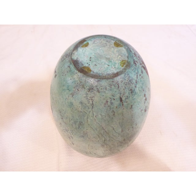 This verdigris bronze vase has a polished rim.