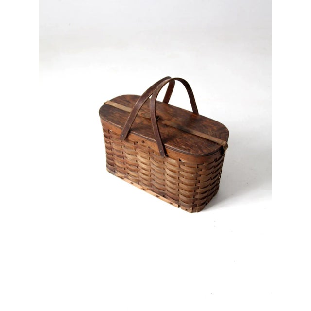 Vintage 1940s–1950s Hawkeye picnic basket with a woven wood body, fitted wood lid, double swing handles, canvas closure...