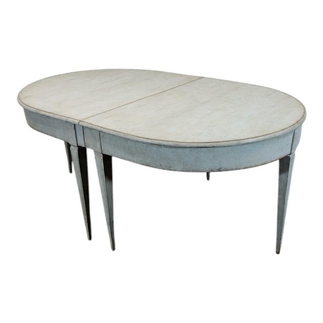 A lovely Swedish dining table in classic Gustavian style dating from the middle of the 19th century. It is finished in a...